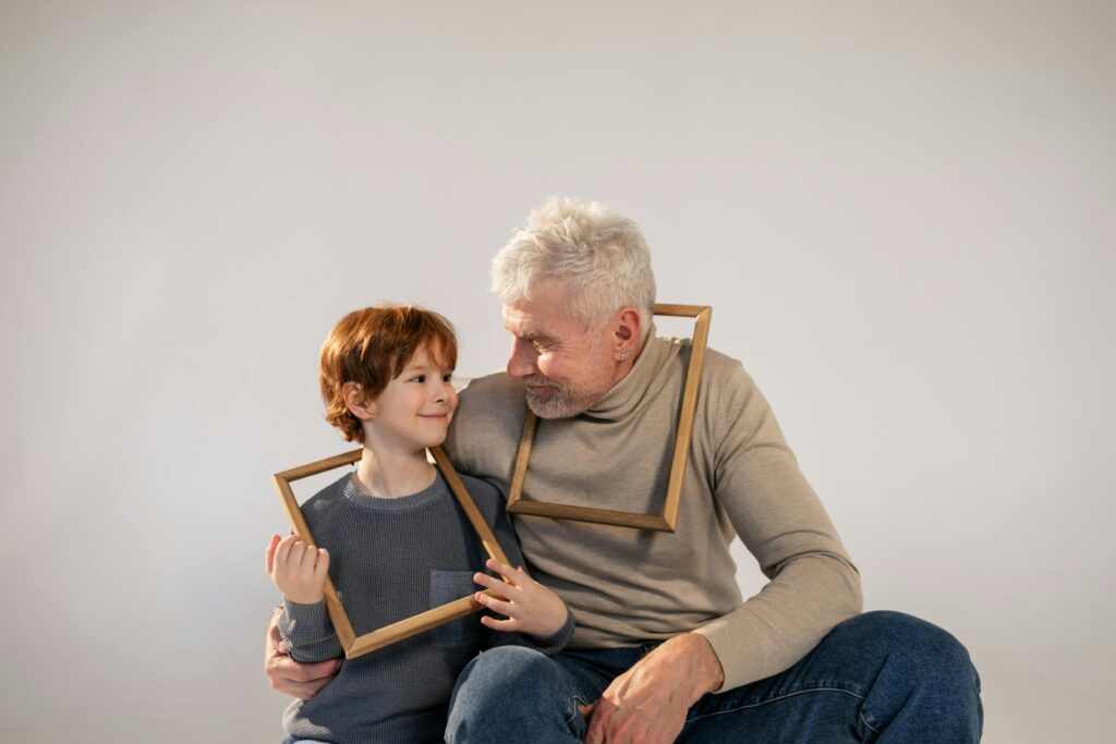 Heartwarming studio portrait of grandfather and grandson sharing a special moment.